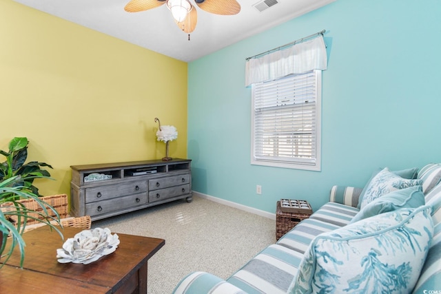 carpeted living room featuring ceiling fan