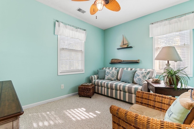 carpeted living room with ceiling fan