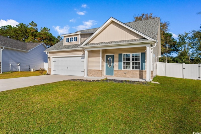 craftsman house with a garage and a front lawn