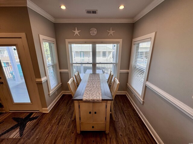 unfurnished dining area with crown molding and dark wood-type flooring