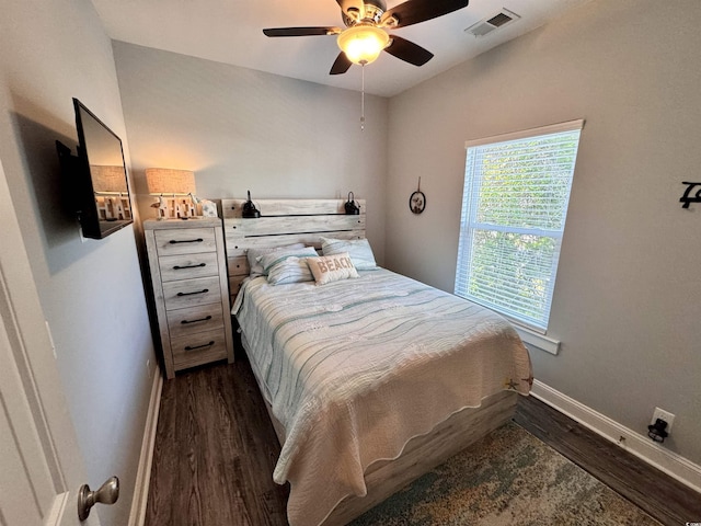 bedroom featuring ceiling fan, dark hardwood / wood-style flooring, and lofted ceiling