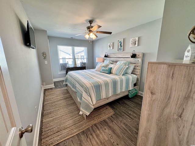 bedroom with ceiling fan and dark hardwood / wood-style flooring