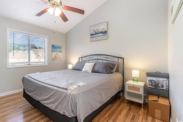 bedroom featuring hardwood / wood-style floors, ceiling fan, and lofted ceiling