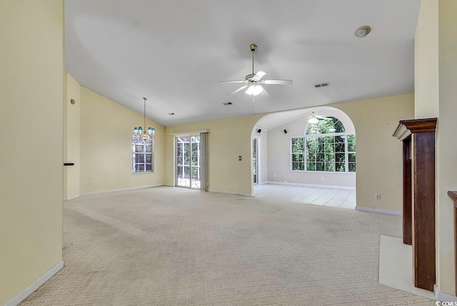 interior space featuring ceiling fan with notable chandelier and high vaulted ceiling