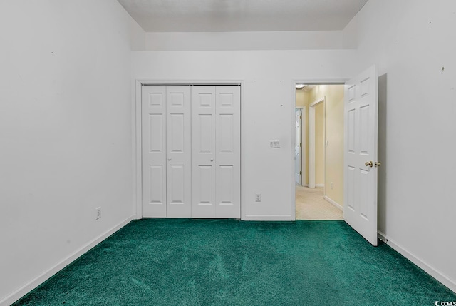 unfurnished bedroom featuring carpet and a closet