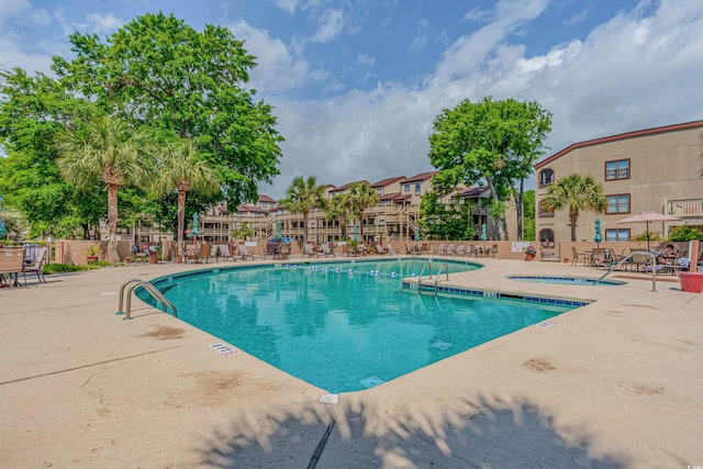 view of swimming pool with a patio