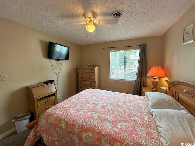 carpeted bedroom featuring a textured ceiling and ceiling fan