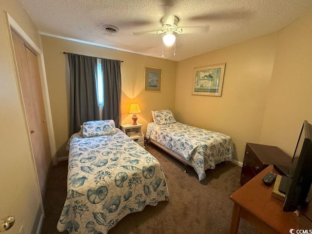 carpeted bedroom with a textured ceiling, a closet, and ceiling fan