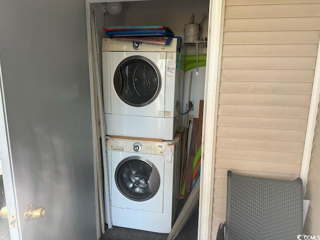 washroom with stacked washer and dryer