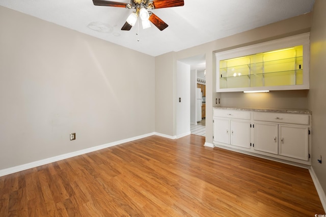 unfurnished living room with ceiling fan and light hardwood / wood-style floors