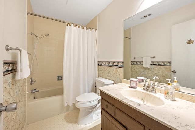 full bathroom featuring tile patterned floors, shower / tub combo with curtain, vanity, and tile walls