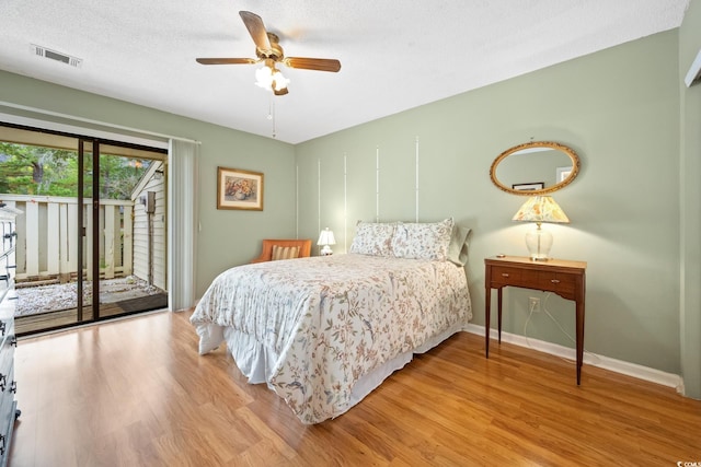 bedroom featuring a textured ceiling, access to outside, light hardwood / wood-style flooring, and ceiling fan