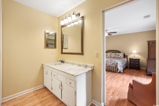 bathroom featuring vanity, hardwood / wood-style flooring, and ceiling fan