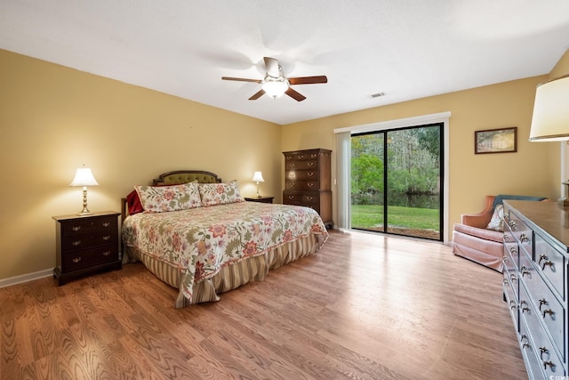 bedroom featuring access to outside, light hardwood / wood-style flooring, and ceiling fan