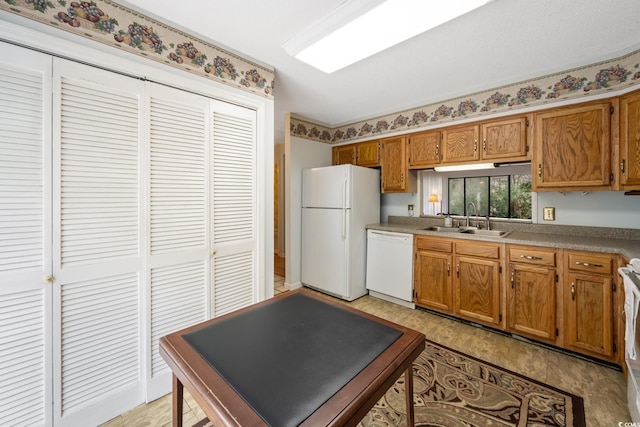 kitchen featuring white appliances and sink