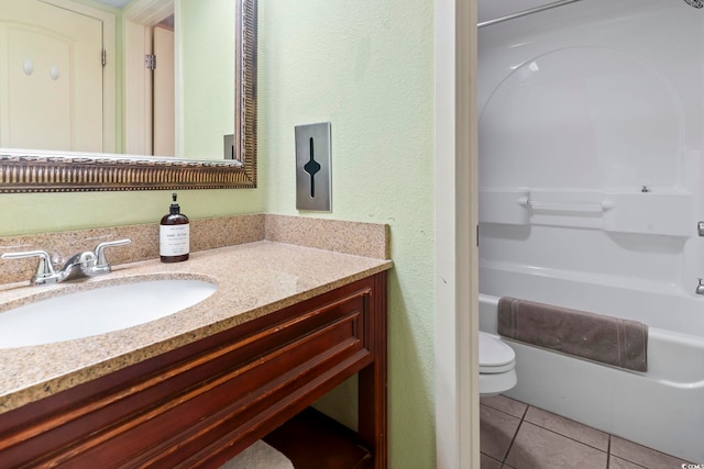 full bathroom with toilet, vanity, tile patterned floors, and tub / shower combination