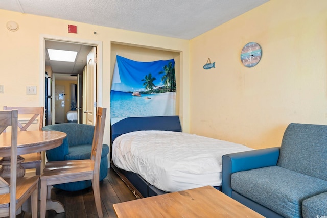 bedroom with wood-type flooring and a textured ceiling