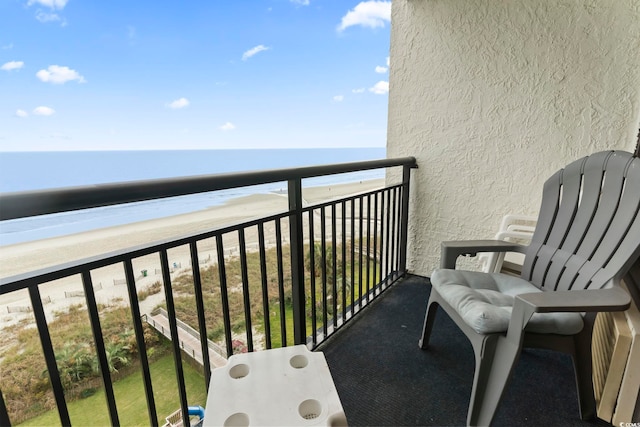 balcony featuring a water view and a view of the beach