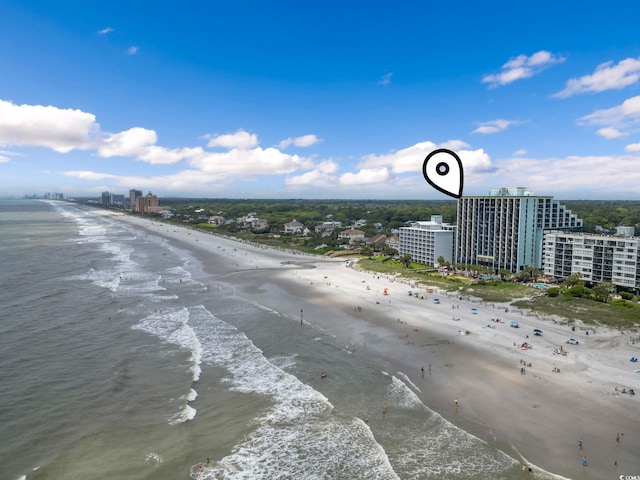 birds eye view of property featuring a beach view and a water view