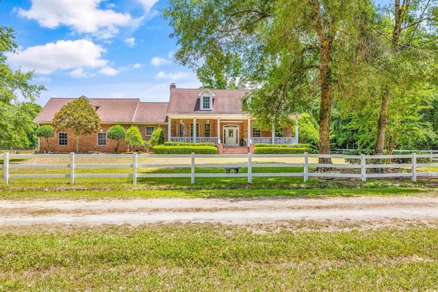 cape cod home featuring a porch