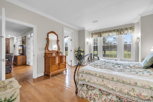 bedroom with light hardwood / wood-style floors and ornamental molding