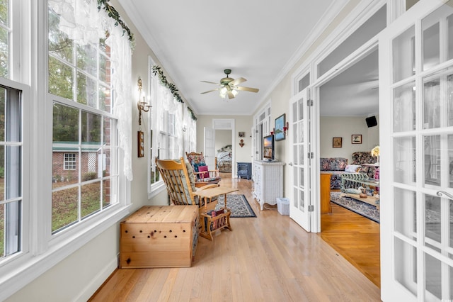 sunroom / solarium featuring ceiling fan and french doors