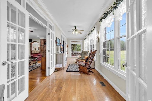 sunroom with french doors, plenty of natural light, and ceiling fan