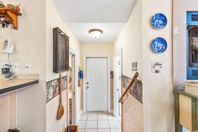 entryway with light tile patterned flooring