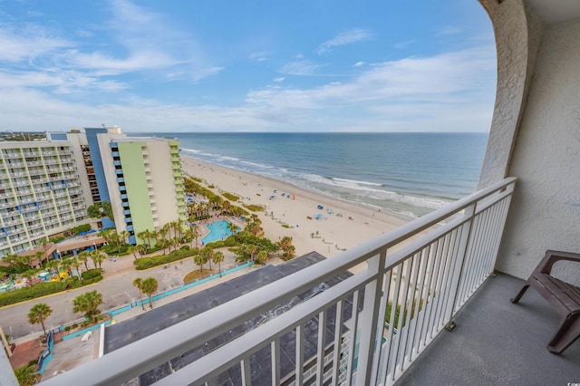 balcony with a water view and a beach view