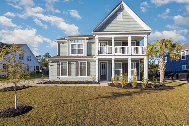 view of front of home featuring a balcony and a front lawn