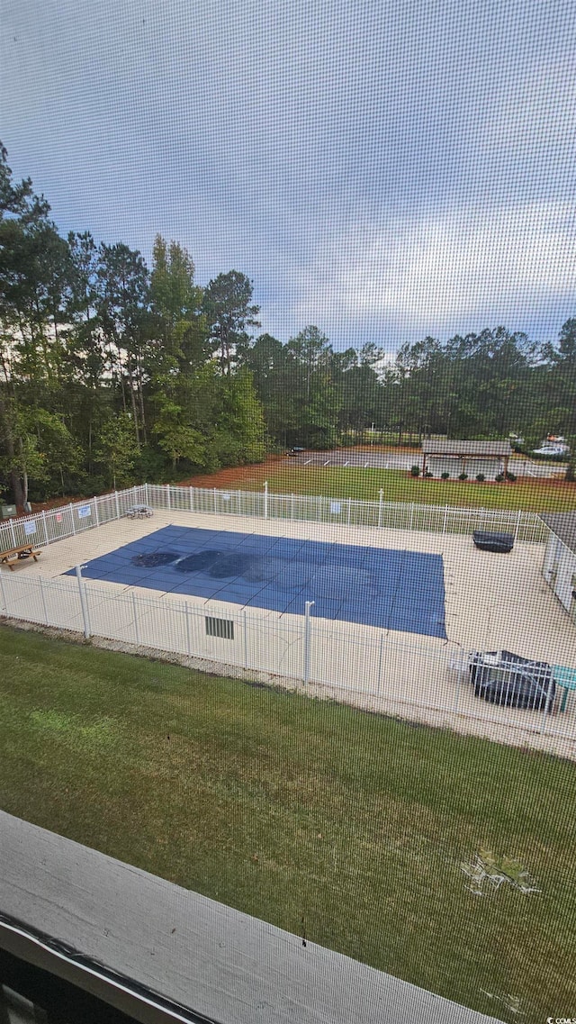 view of swimming pool with a yard and a patio area