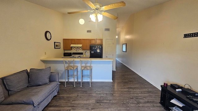 living room with dark hardwood / wood-style flooring, high vaulted ceiling, and ceiling fan