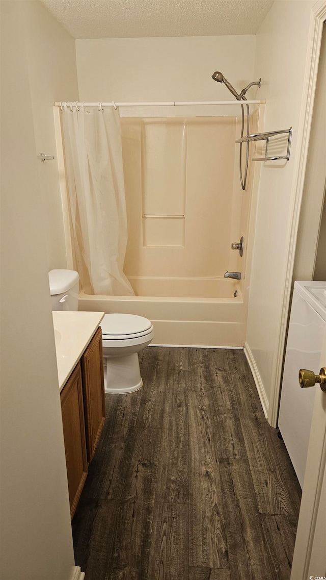 full bathroom featuring vanity, a textured ceiling, hardwood / wood-style flooring, and toilet