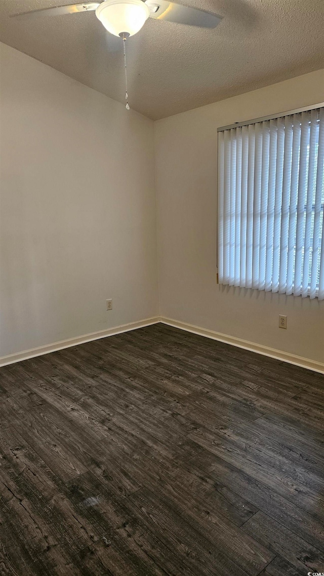 spare room with a textured ceiling, dark hardwood / wood-style floors, and ceiling fan