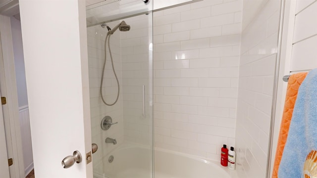 bathroom with shower / bath combination with glass door