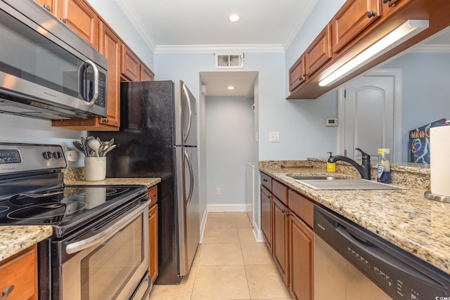 kitchen with light stone countertops, sink, stainless steel appliances, light tile patterned flooring, and ornamental molding