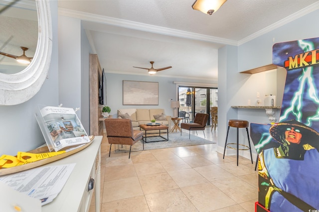 interior space featuring light tile patterned floors, a textured ceiling, ceiling fan, and ornamental molding