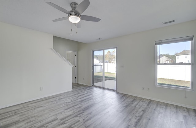 spare room with ceiling fan and light wood-type flooring