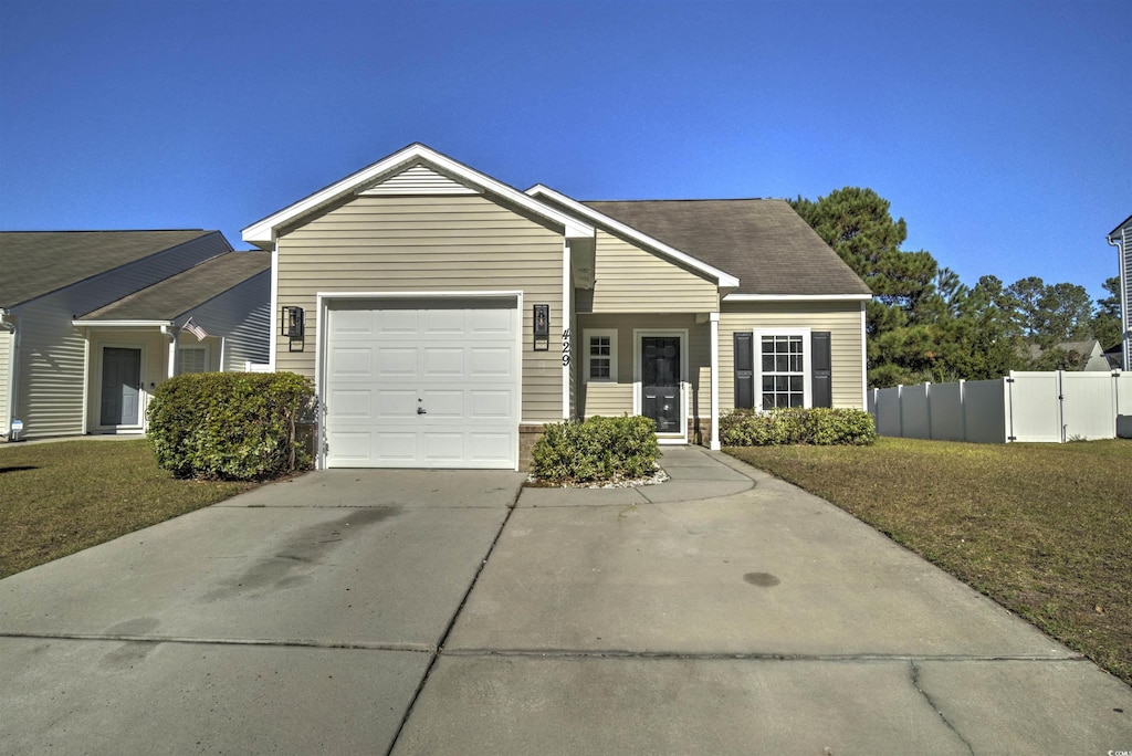 ranch-style home with a front yard and a garage