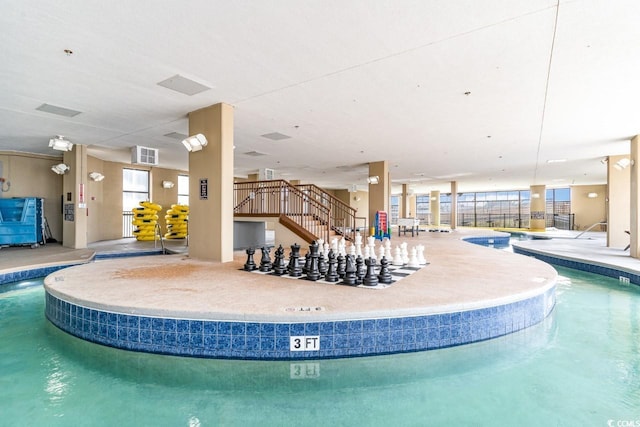 view of swimming pool featuring a hot tub