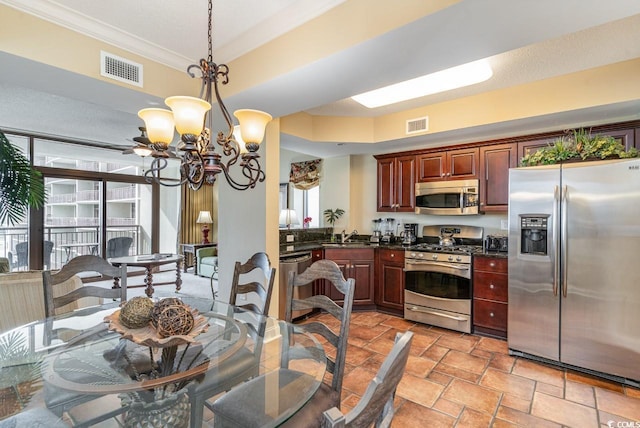 kitchen with crown molding, sink, hanging light fixtures, stainless steel appliances, and a chandelier