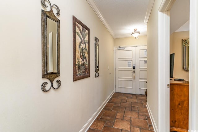 corridor with a textured ceiling and crown molding