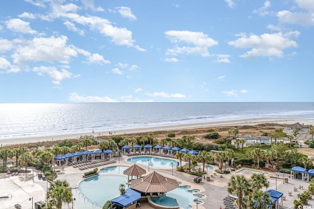 drone / aerial view with a water view and a beach view