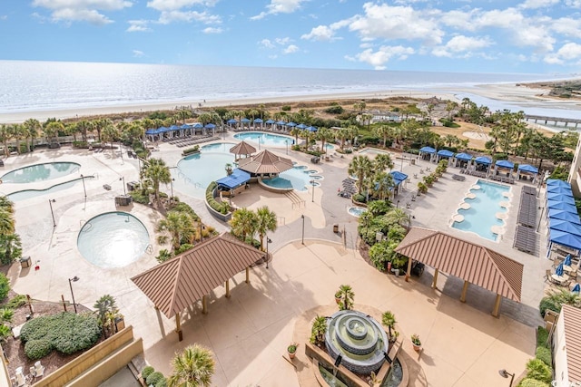 drone / aerial view featuring a water view and a beach view