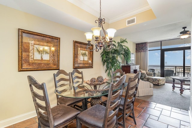 carpeted dining room featuring ceiling fan with notable chandelier, floor to ceiling windows, and crown molding