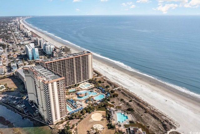 bird's eye view with a water view and a beach view