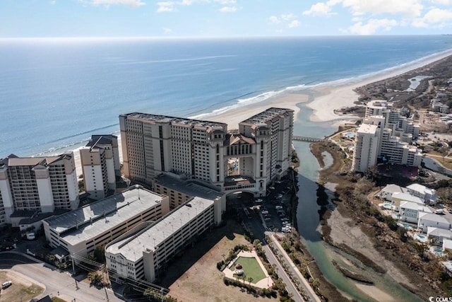 bird's eye view featuring a water view and a beach view