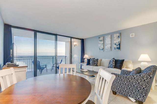 tiled dining space featuring expansive windows