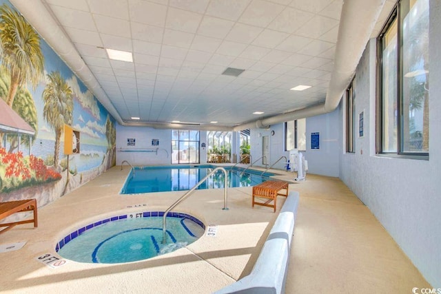 view of swimming pool featuring an indoor hot tub