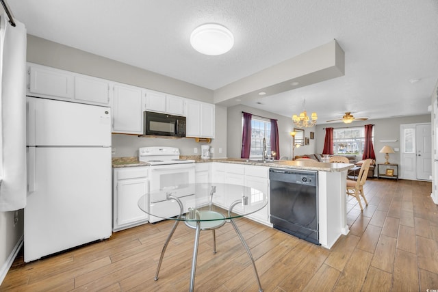 kitchen featuring kitchen peninsula, light wood-type flooring, ceiling fan, black appliances, and white cabinetry